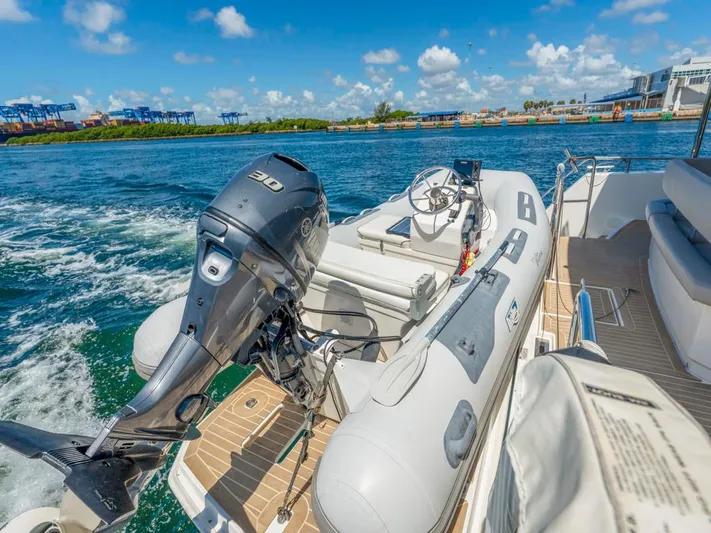 Breathe Yacht Photos Pics 2020 Leopard 53 Powercat with dinghy and outboard motor on deck, cruising in sunny waters.