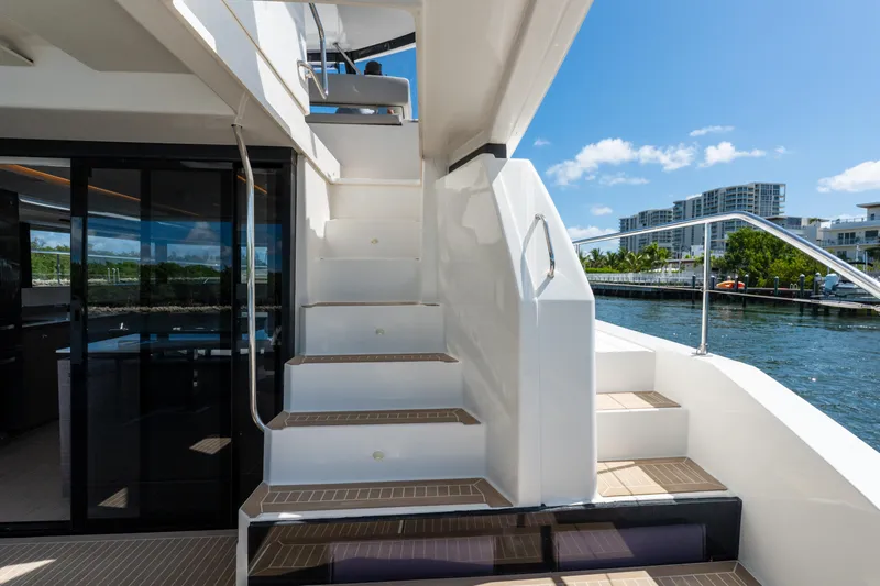 Breathe Yacht Photos Pics Staircase on 2020 Leopard 53 Powercat yacht with waterfront view.