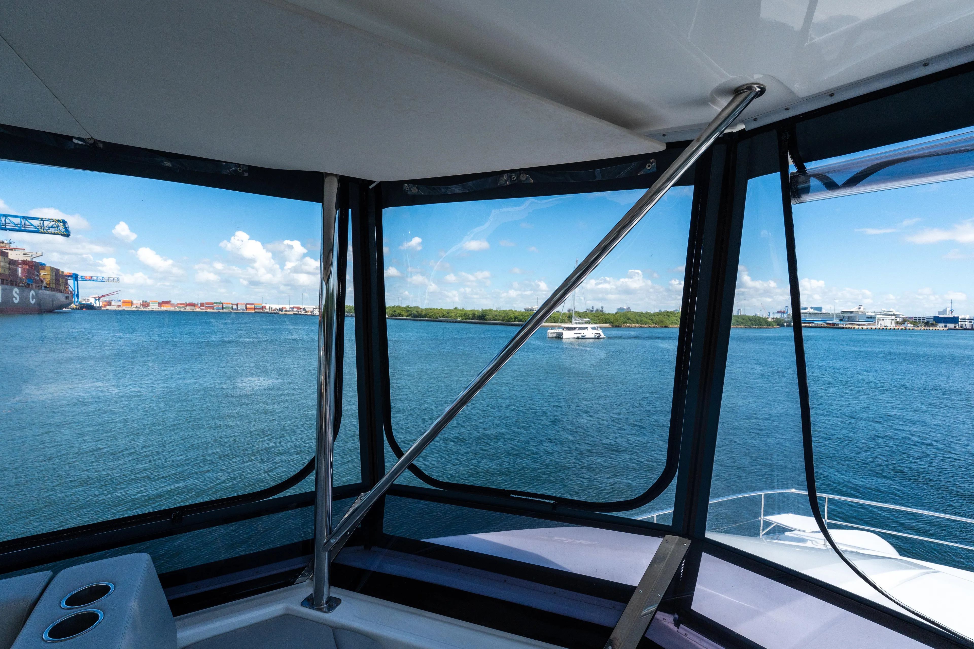 Breathe Yacht Photos Pics View from Leopard 53 Powercat 2020, overlooking serene waters and distant ships.