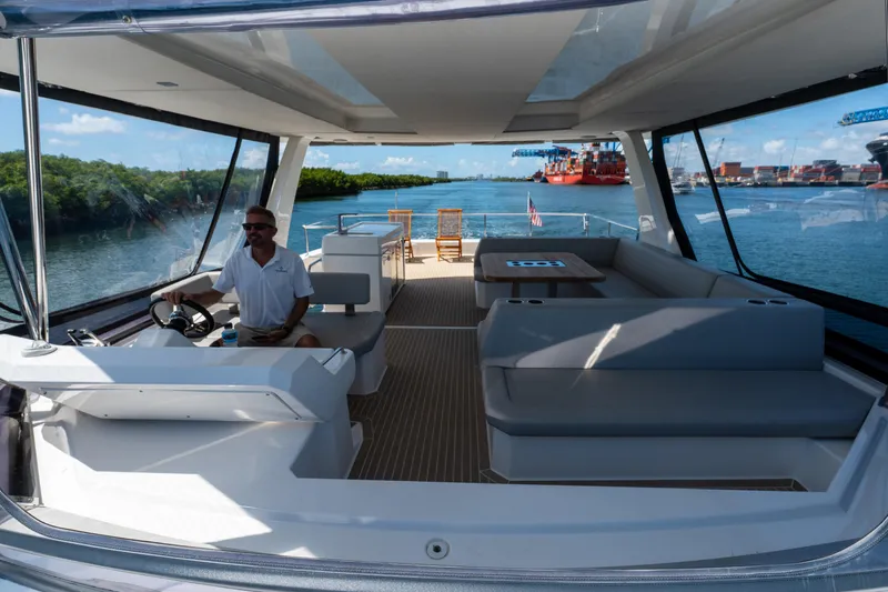 Breathe Yacht Photos Pics Luxurious 2020 Leopard 53 Powercat yacht interior with spacious seating and scenic waterway view.