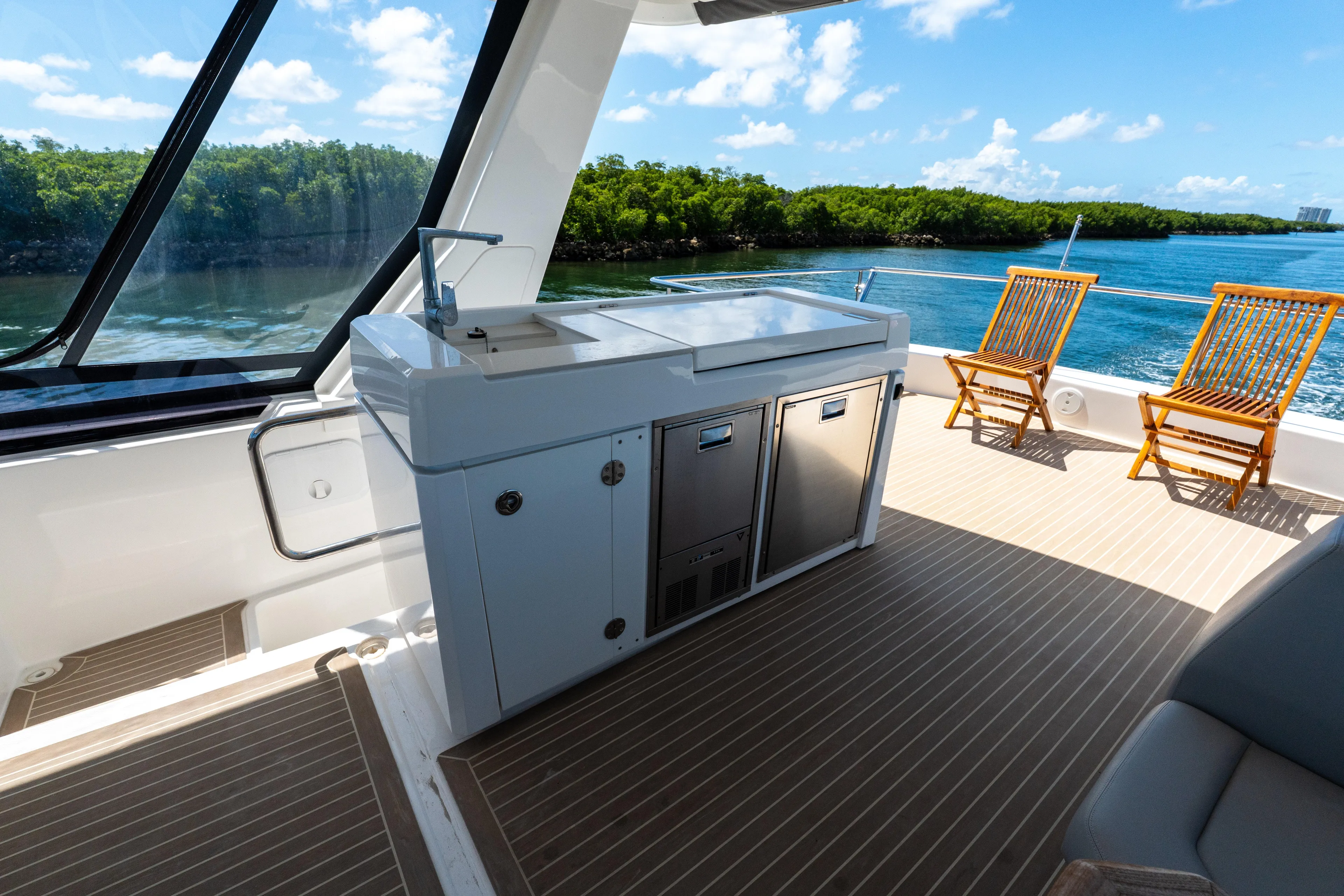 Breathe Yacht Photos Pics 2020 Leopard 53 Powercat yacht deck with outdoor kitchen and scenic water view.