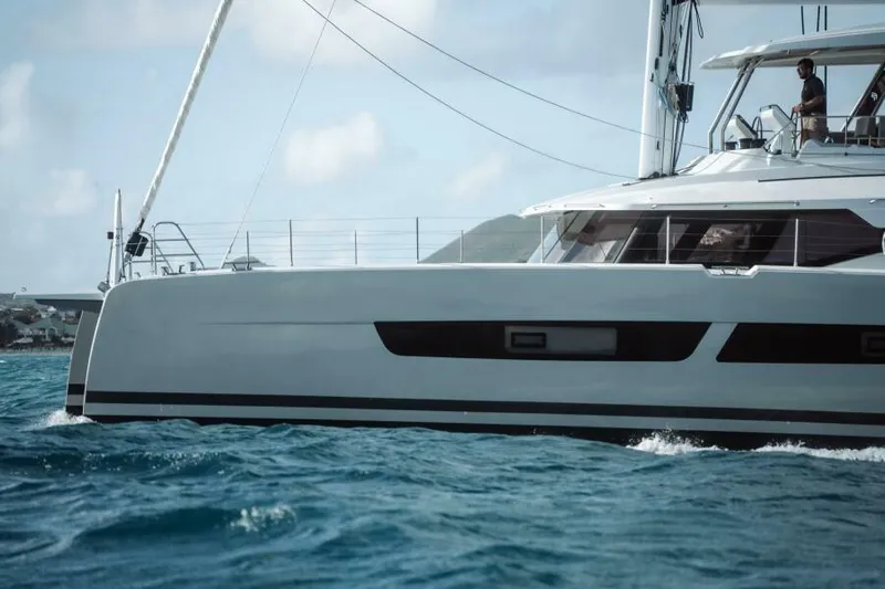 Roamance Yacht Photos Pics 2022 Fountaine Pajot Alegria 67 catamaran sailing on blue ocean waters.