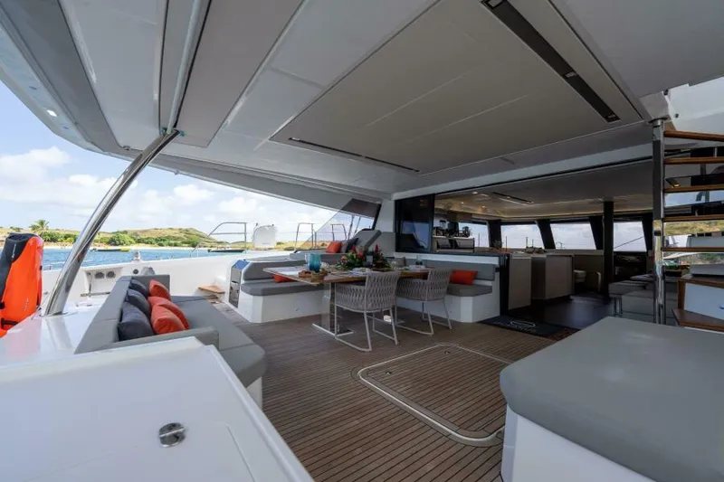 Roamance Yacht Photos Pics Luxurious 2022 Fountaine Pajot Alegria 67 yacht interior with elegant seating and dining area.