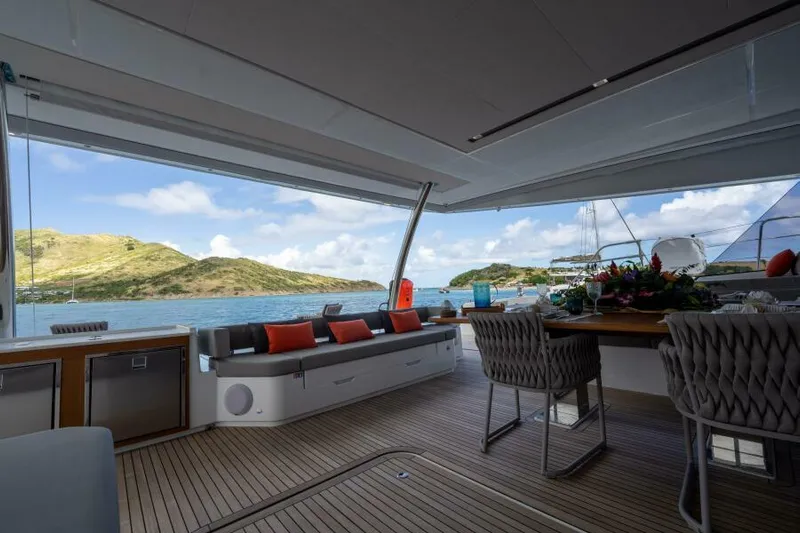 Roamance Yacht Photos Pics Luxury deck of 2022 Fountaine Pajot Alegria 67 yacht with scenic ocean view.