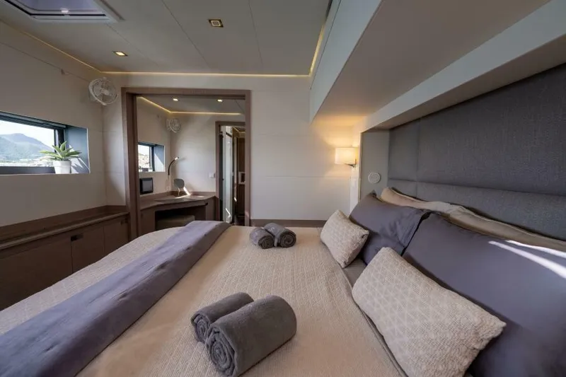 Roamance Yacht Photos Pics Luxurious bedroom interior of 2022 Fountaine Pajot Alegria 67 yacht with elegant decor.