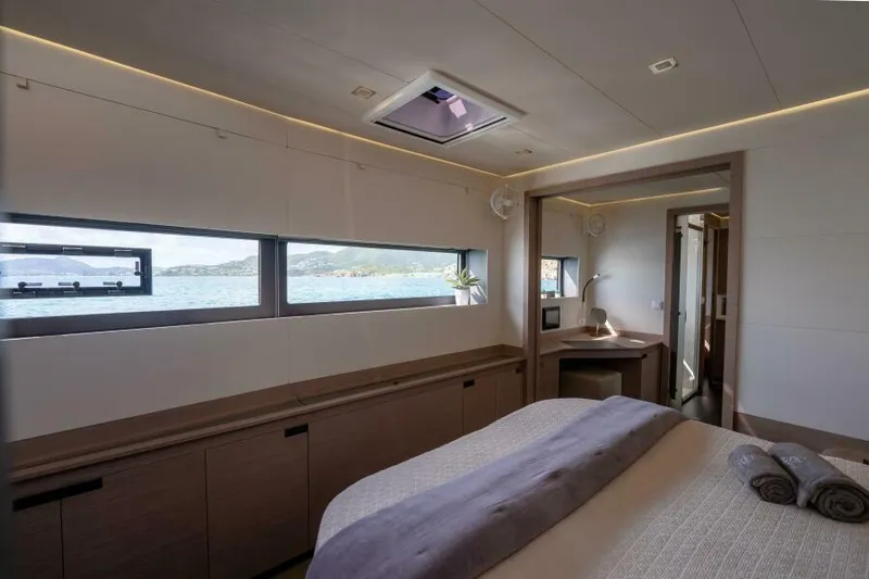 Roamance Yacht Photos Pics Luxurious bedroom interior of 2022 Fountaine Pajot Alegria 67 yacht with ocean view.