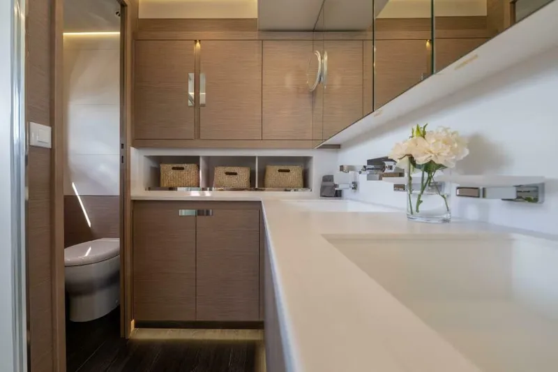 Roamance Yacht Photos Pics Luxurious bathroom interior of 2022 Fountaine Pajot Alegria 67 yacht, featuring modern cabinetry.