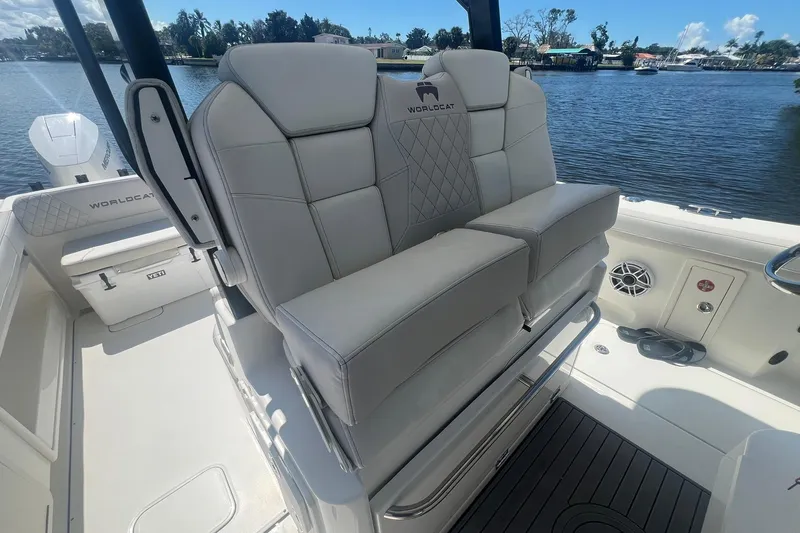  Yacht Photos Pics 2024 World Cat 325 CC boat interior with plush seating and scenic waterfront view.