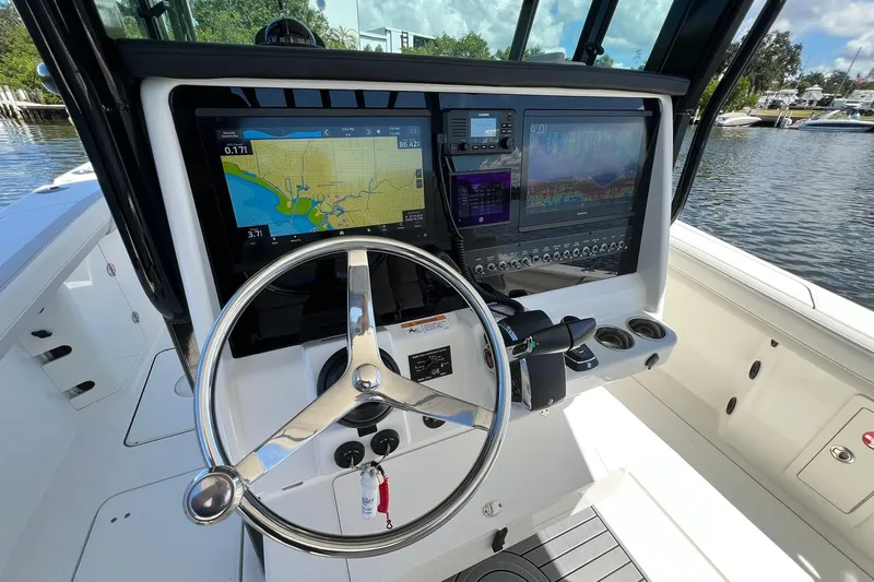  Yacht Photos Pics 2024 World Cat 325 CC boat helm with navigation screens and steering wheel.