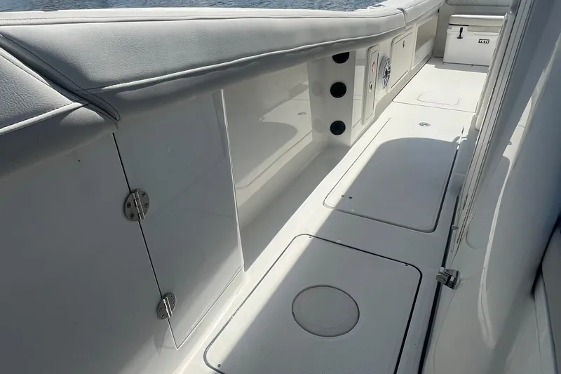  Yacht Photos Pics 2024 World Cat 325 CC boat interior with sleek white deck and storage compartments.