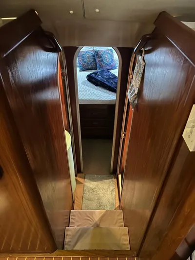  Yacht Photos Pics 1994 Luhrs 380 Tournament interior with wooden cabinetry and cozy bedroom view.