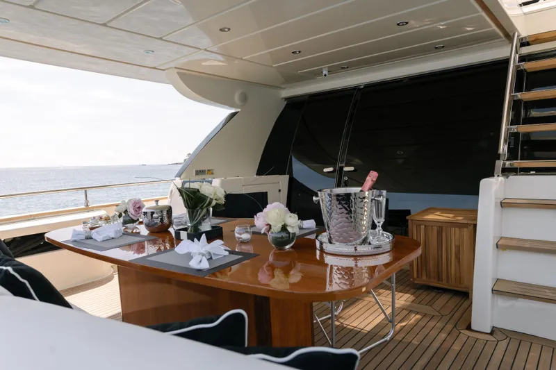 Milky Way Yacht Photos Pics Luxurious 2007 Riva Venere 75 yacht deck with elegant dining setup and ocean view.
