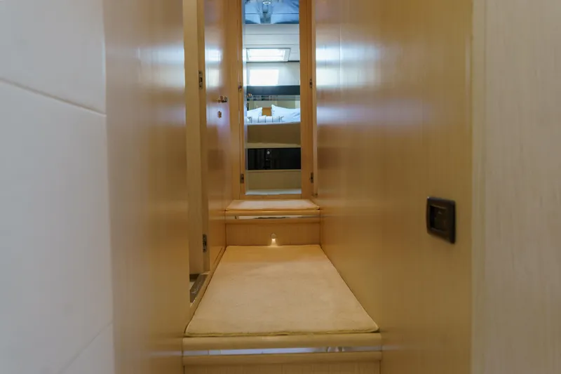 Milky Way Yacht Photos Pics Interior hallway of 2007 Riva Venere 75 yacht with wooden finish and soft lighting.