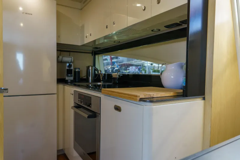 Milky Way Yacht Photos Pics Modern kitchen interior on 2007 Riva Venere 75 yacht, featuring sleek appliances and cabinetry.