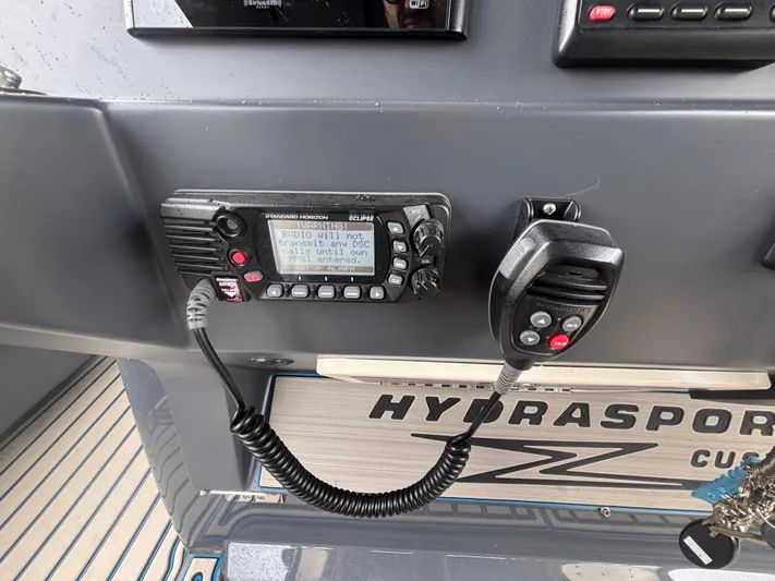  Yacht Photos Pics Control panel of a 2016 Hydra-Sports 4200 Siesta with marine radio and microphone.