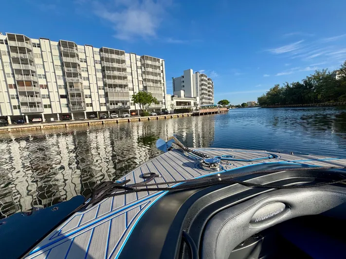  Yacht Photos Pics 2016 Hydra-Sports 4200 Siesta boat on a calm waterway near modern buildings.