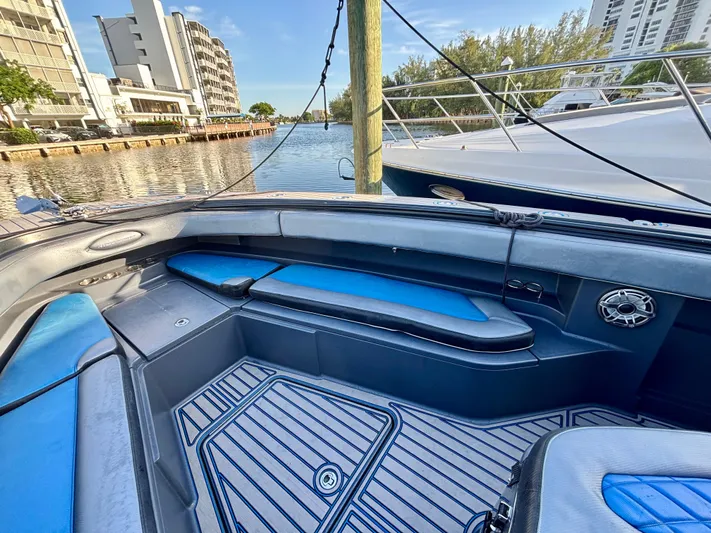  Yacht Photos Pics 2016 Hydra-Sports 4200 Siesta boat interior with blue seating, docked near waterfront buildings.