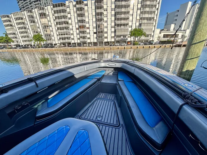  Yacht Photos Pics 2016 Hydra-Sports 4200 Siesta boat interior with blue seating, docked near waterfront buildings.