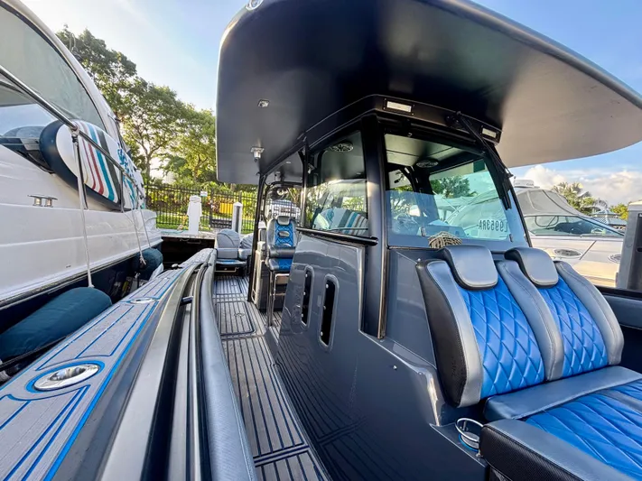  Yacht Photos Pics 2016 Hydra-Sports 4200 Siesta boat with blue seating and sleek design at a marina.