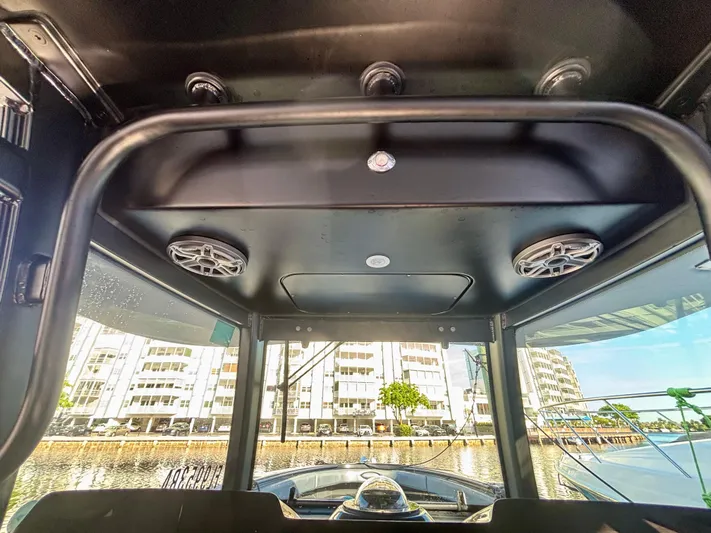  Yacht Photos Pics Interior view of 2016 Hydra-Sports 4200 Siesta boat with speakers and cityscape background.