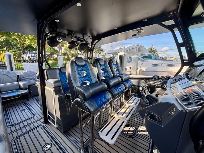  Yacht Photos Pics 2016 Hydra-Sports 4200 Siesta boat interior with blue and black seating, docked at marina.