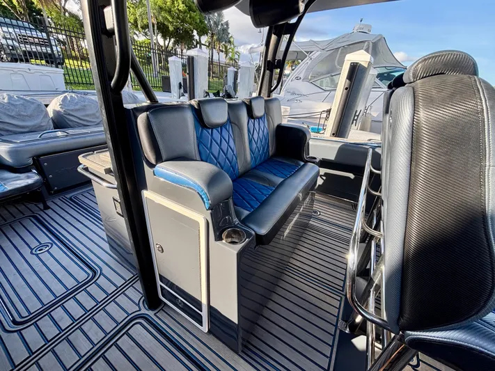  Yacht Photos Pics 2016 Hydra-Sports 4200 Siesta interior with blue and black seating, docked near other boats.