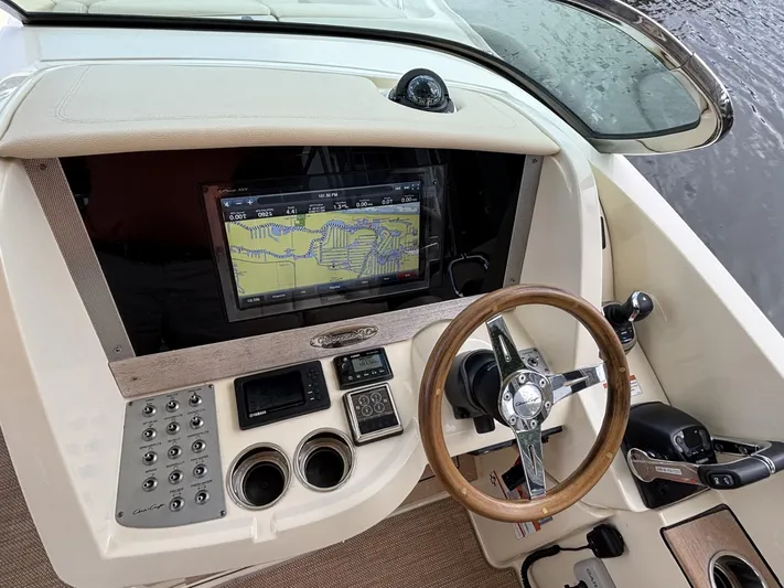  Yacht Photos Pics 2019 Chris-Craft Calypso 30 dashboard with navigation screen and steering wheel.