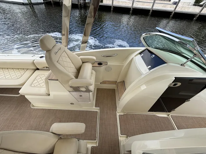  Yacht Photos Pics 2019 Chris-Craft Calypso 30 boat interior with luxurious seating and helm, docked by the water.