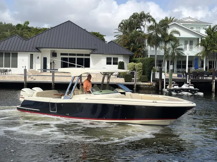  Yacht Photos Pics 2019 Chris-Craft Calypso 30 boat cruising near waterfront homes.