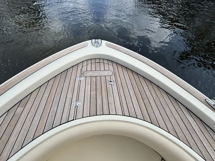  Yacht Photos Pics Bow of 2019 Chris-Craft Calypso 30 with teak decking on calm water.