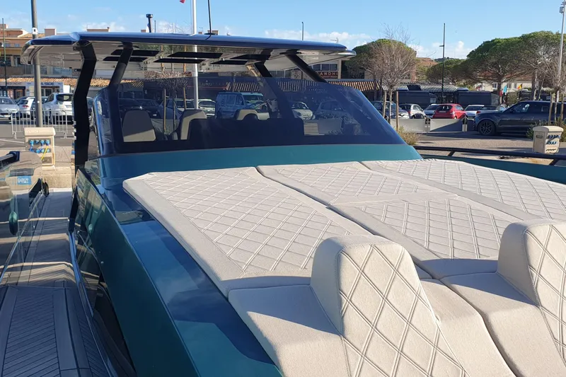  Yacht Photos Pics 2023 Canados Gladiator 493 yacht with luxurious deck and seating in marina setting.