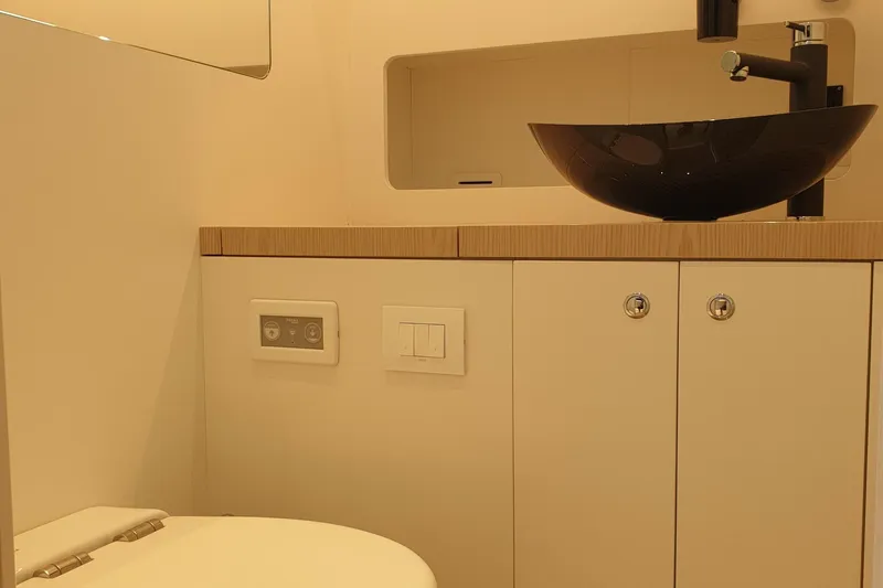  Yacht Photos Pics Luxury bathroom interior of 2023 Canados Gladiator 493 yacht, featuring modern sink and fixtures.