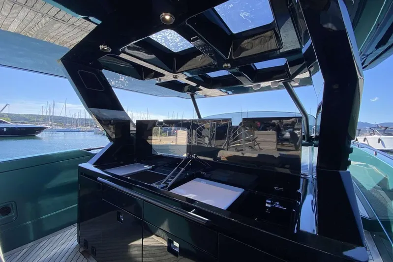  Yacht Photos Pics 2023 Canados Gladiator 493 yacht interior with sleek black design and modern amenities.
