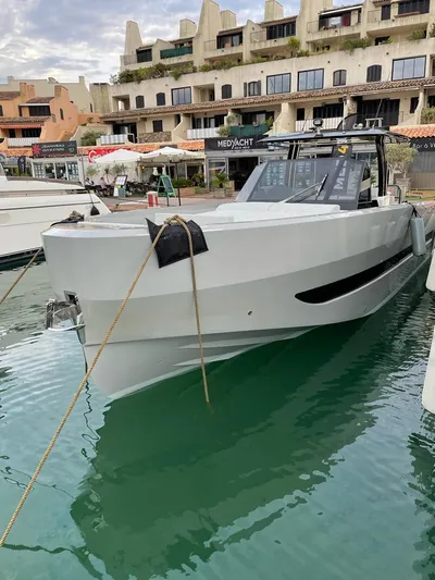  Yacht Photos Pics 2023 MedYacht 42 docked in marina, modern design, calm water, overcast sky.