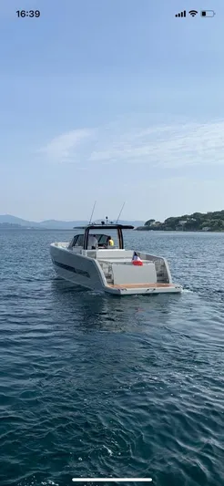  Yacht Photos Pics 2023 MedYacht 42 cruising on calm blue waters near a scenic coastline.