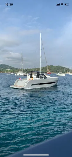  Yacht Photos Pics 2023 MedYacht 42 cruising on clear blue waters, surrounded by sailboats.