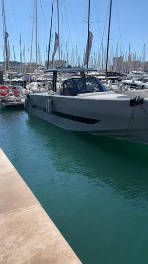  Yacht Photos Pics 2023 MedYacht 42 docked in a marina, surrounded by sailboats under clear blue skies.