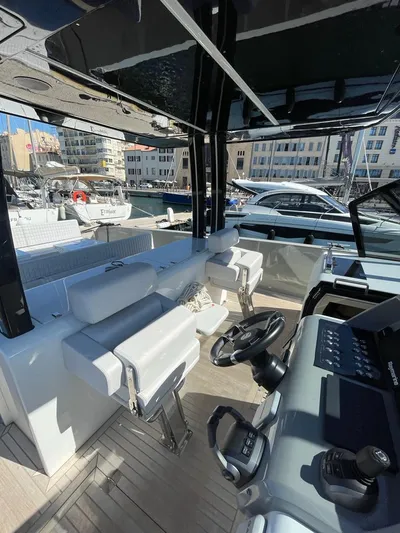  Yacht Photos Pics Interior view of 2023 MedYacht 42, featuring modern helm and seating at a marina.