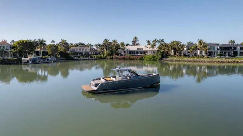  Yacht Photos Pics 2025 Pardo Yachts 43 on tranquil water, surrounded by luxury waterfront homes and palm trees.