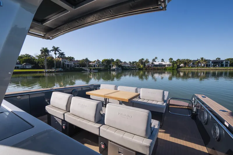  Yacht Photos Pics Luxurious 2025 Pardo Yachts 43 with elegant seating, cruising on a serene waterfront.