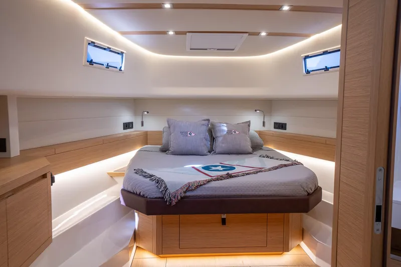  Yacht Photos Pics Luxurious cabin interior of 2025 Pardo Yachts 43, featuring elegant wood finishes and ambient lighting.