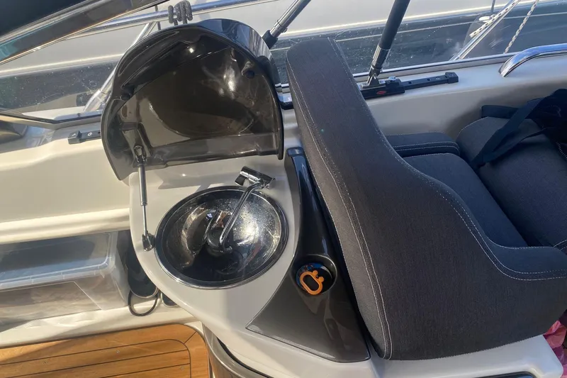  Yacht Photos Pics 2009 Cranchi Endurance 33 boat interior with steering wheel and seating area.