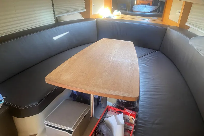  Yacht Photos Pics Interior of 2009 Cranchi Endurance 33 with leather seating and wooden table.