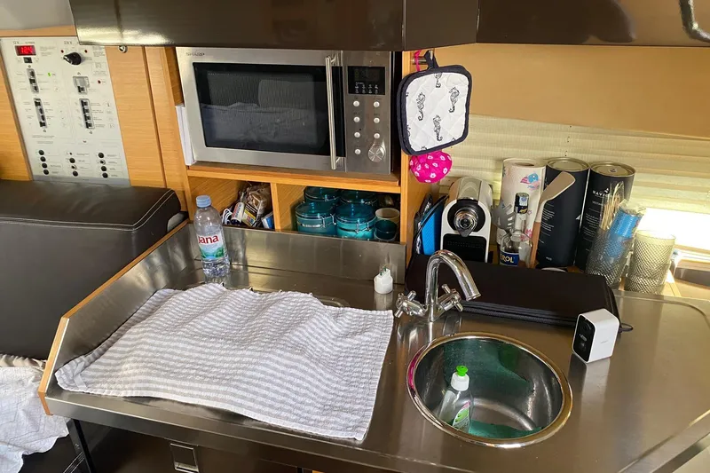  Yacht Photos Pics Interior of 2009 Cranchi Endurance 33 yacht kitchen with sink, microwave, and storage.