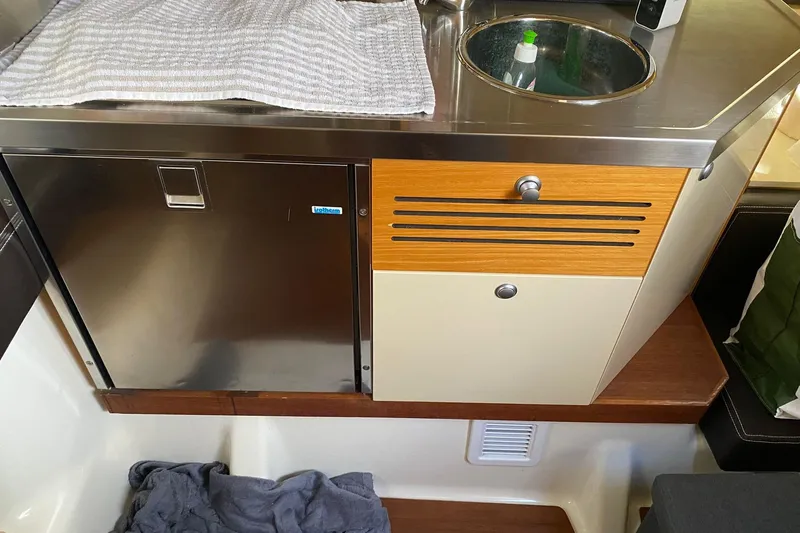  Yacht Photos Pics 2009 Cranchi Endurance 33 yacht kitchenette with stainless steel sink and cabinetry.