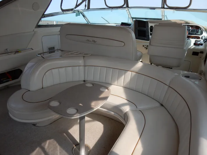 Sandi Yacht Photos Pics Luxurious interior of a 1997 Sea Ray 450 yacht with plush seating and table.