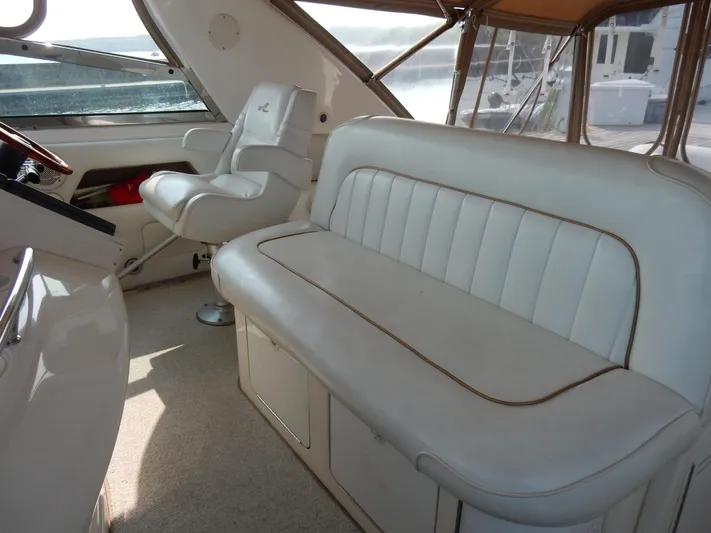 Sandi Yacht Photos Pics 1997 Sea Ray 450 yacht interior with white leather seating and helm chair.