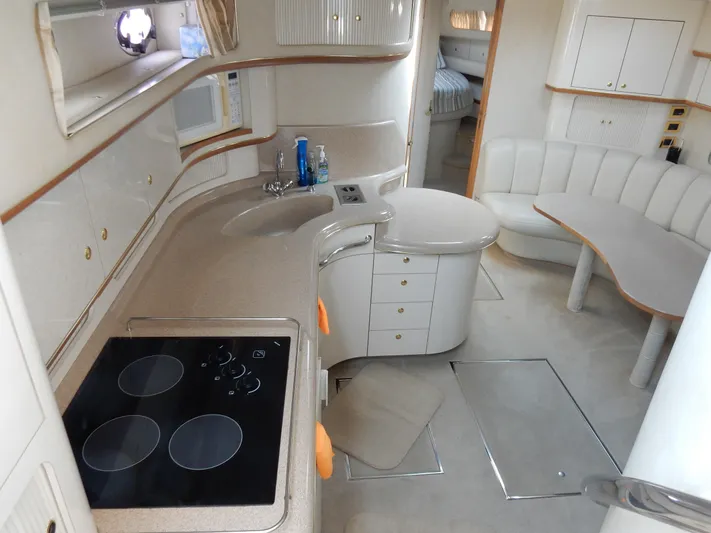 Sandi Yacht Photos Pics Interior of 1997 Sea Ray 450 yacht with kitchen and seating area.