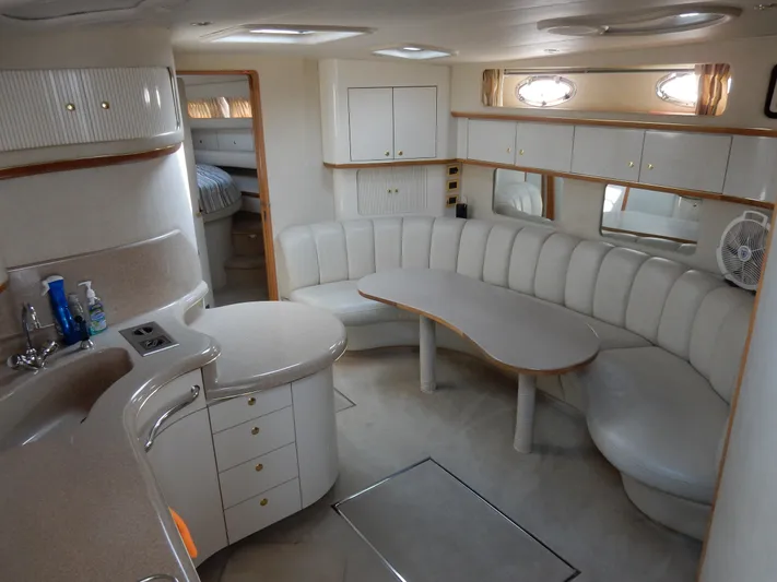 Sandi Yacht Photos Pics Luxurious interior of a 1997 Sea Ray 450 yacht with elegant seating and cabinetry.