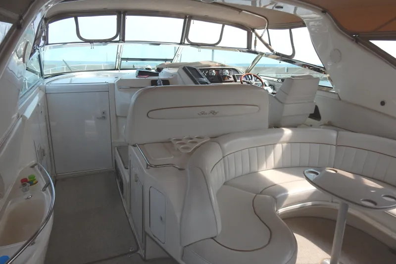 Sandi Yacht Photos Pics 1997 Sea Ray 450 yacht interior with white seating and helm, showcasing luxury design.